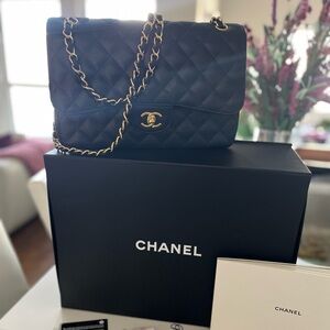 Timeless Classic Jumbo Flapbag Caviar Chanel Handbag with Gold Hardware.